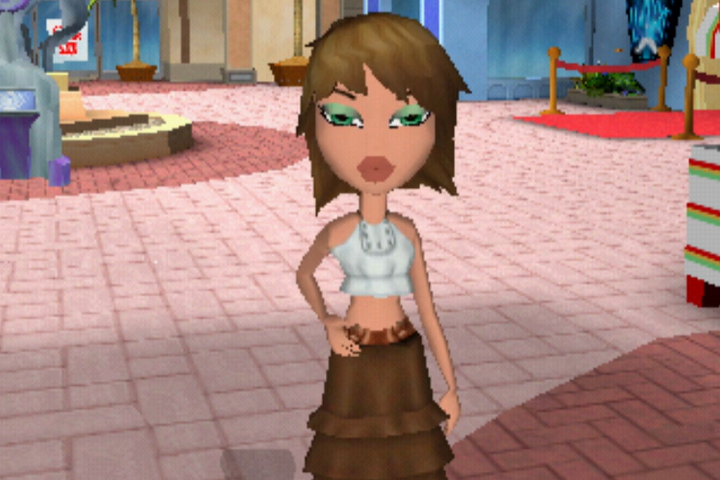 Fianna has short brown hair styled in a bob. Her skin is light. She wears a cropped white tank top and a brown ruffled skirt. Her eyes are green.