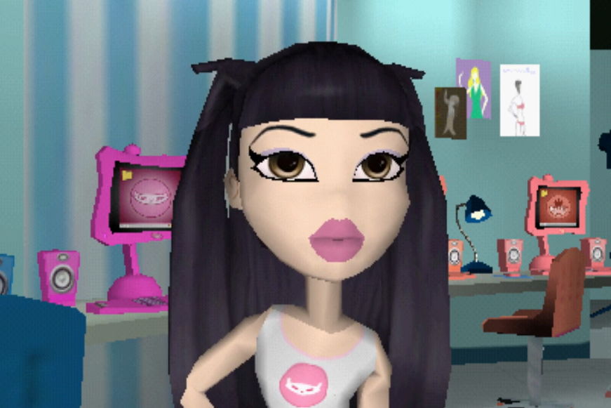 Jade is pale and has black hair worn in pigtails that go down to her waist. Her eyes are brown. She is wearing a white shirt with a pink logo of a cat on it. This logo is her character logo.
