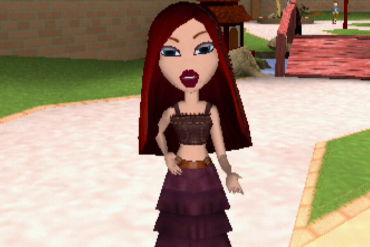 Roxxi has long deep red hair and pale skin. She wears a cropped brown tank top and an eggplant ruffled skirt. Her eyes are blue.